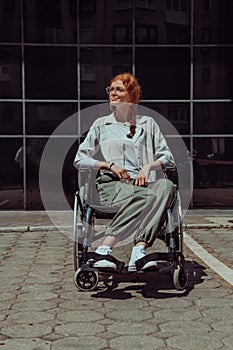 In front of a modern corporate building, a young woman sitting in a wheelchair confidently, symbolizing empowerment