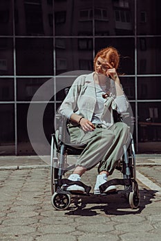In front of a modern corporate building, a young woman sitting in a wheelchair confidently, symbolizing empowerment