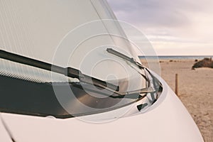 Front nose of motor home rv recreational vehicle camper van parked at the beach in free adventure travel vacation concept