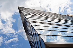 Front of the office building with clouds reflections