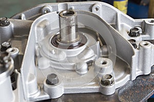 The front oil seal of the crankshaft of an automobile engine mounted on a partially disassembled engine