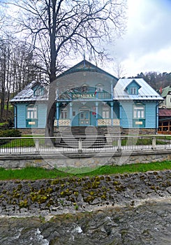 Front of old wooden blue house with Nikifor Museum in Nowy Sacz, Poland.