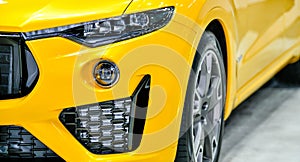 Front one headlights of modern yellow car