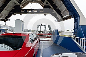 Front open door of passenger freight cargo ferry boat vessel ship with loaded cars and vehicles. Sea transportation