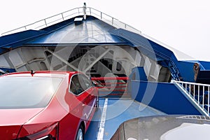 Front open door of passenger freight cargo ferry boat vessel ship with loaded cars and vehicles. Sea transportation