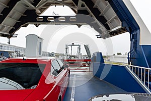 Front open door of passenger freight cargo ferry boat vessel ship with loaded cars and vehicles. Sea transportation photo