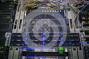 Front panel of central data server. Powerful computing equipment works in the server room. Rack with hosting servers of large web