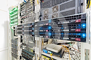 Front panel of central data server. Powerful computing equipment works in the server room. Rack with hosting servers of large web