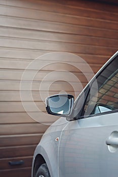 Front part of the car parked at garage doors.