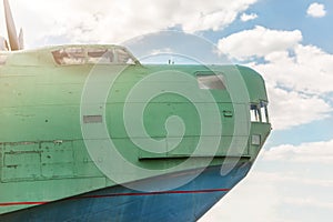 Front part of old amhibian plane against blue sky. Vintage anti-submarine military hydroplane aircraft . Toned