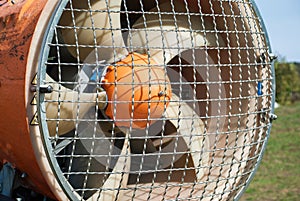 Front part of the snow cannon on a ski slope, detail of the protection mesh and the blades in a duct. Detail of ducted fan of a photo