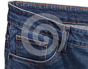 Front pocket and waist areas of dark blue jeans isolated on white background. Close up shot. Clothing concept