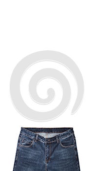 Front pockets, waist area, zipper, and its button of dark blue jeans isolated on white background. Close up shot. Copy space above