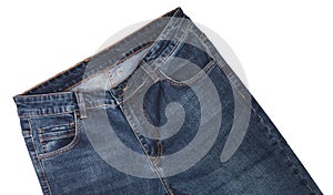 Front pockets, waist area, zipper, and its button of dark blue jeans slightly tilted and isolated on white background. Close up