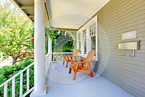 Front porch with chairs and columns.