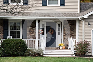 Front porch of resedential home with autumn decorations