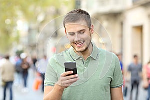 Front portrait of a man using a smart phone