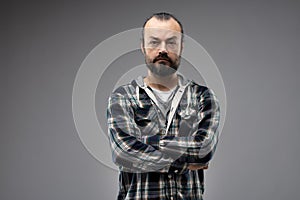 Front portrait of serious man with crossed arms