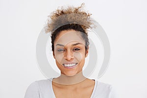 Front portrait of young african american woman smiling against white background