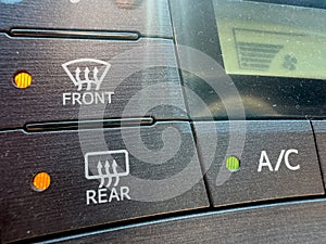 Front and rear defrost button closeup