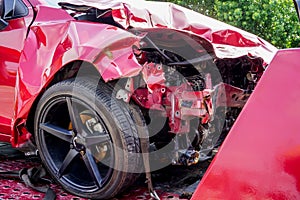 Front of red car get damaged by accident on the road