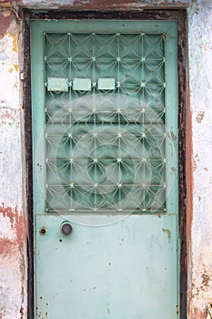 Front shoot of traditional green metal door in turkish village