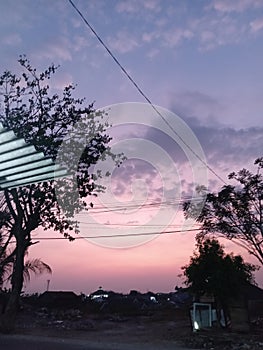 In front of the shop and look the sunset.