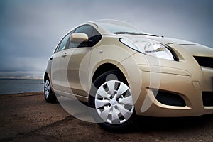 Front-side closeup of a beige car
