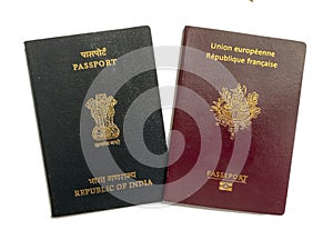 Front side covers of India and France passports on white background