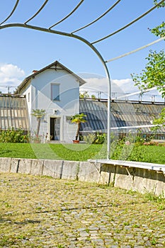 Front side of the greenhouse building and a hallway at the Tivoli Park in Ljubljana, Slovenia\'s capital. Vertical framed.