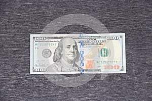 Front side of hundred dollar bill. One hundred dollars on gray background