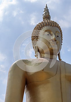 Front side of the large golden Buddha statue with the smiley face