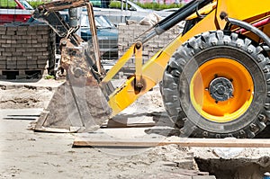 Front side shovel and tire of earth mover and loader bulldozer excavator construction machinery on the street