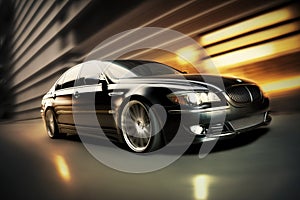 Front side view of black luxury sedan in turn, Fast Blur Background