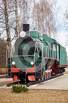 Front side view of classic old green soviet steam locomotive with red star