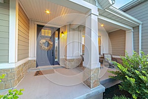 Front and sidelight of home with front porch and wood siding exetrior wall