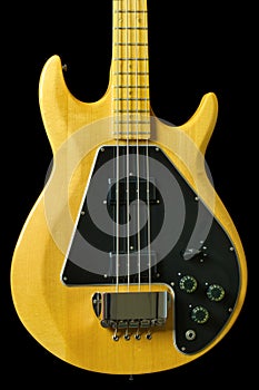 The Front of a Solid Maple Bass Guitar with fine grain, knobs and switches