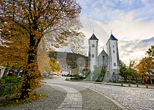 In front of St.Mary`s Church in autumn The foreground is a tree with beautiful yellow leaves