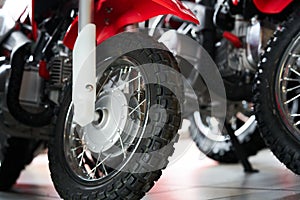 The front tire of a parked custom motorcycle