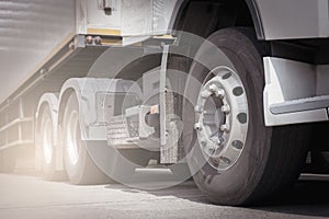 Front a truck wheels. Semi truck trailer parking. Road freight transportation.
