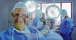 Front view of active Caucasian senior man standing in operation theater