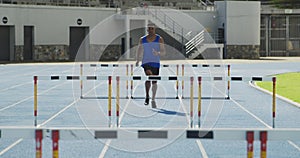 Front view of african american athlete doing hurdling