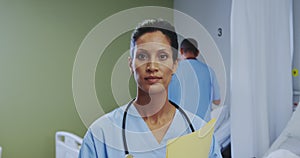 Front view of African american female doctor looking at camera in the ward at hospital