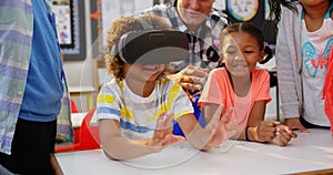 Front view of African american schoolboy using virtual reality headset in the classroom 4k