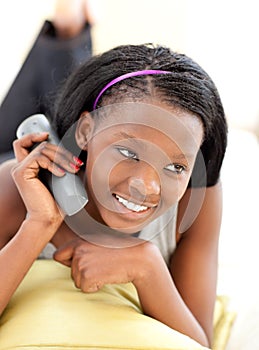 Front view of an african woman watching tv