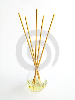 Front view of air freshener with natural wooden sticks isolated on white background. Essential oil bottle for Aromatherapy spa.