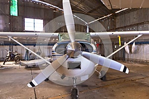 front view of aircraft inside hangar