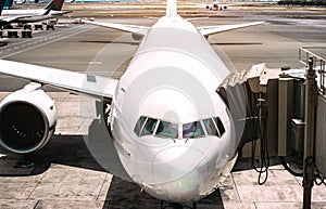 Front view of airplane near airport runway ready to takeoff - Wanderlust travel concept around the world with air plane