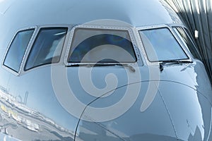 Close up of a jet airplane cockpit Front view of the airplane window with windshield wipers.