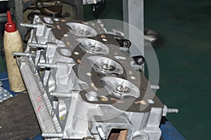 Front view at an angle of the inverted block head of the engine that lies on the desktop